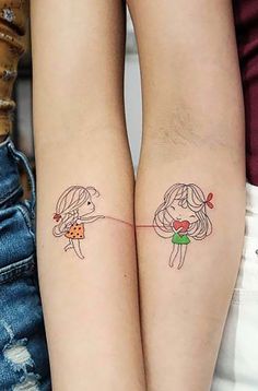 two girls with matching tattoos on their arms, one holding the other's hand