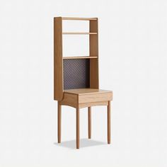 a small wooden shelf with a chair on it's side and shelves above it