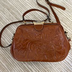 Patricia Nash Tooled Leather Bag With Adjustable Removable Crossbody Strap. Brand New Without Tags. Excellent Leather Suede Interior. Dimensions: 11in X 8in X 3.5in Brown Handheld Satchel For On-the-go, Brown Box Bag With Detachable Handle For Daily Use, Classic Light Brown Satchel With Removable Pouch, Dark Tan Rectangular Shoulder Bag With Adjustable Strap, Rectangular Dark Tan Shoulder Bag With Adjustable Strap, Brown Satchel With Top Handle And Removable Pouch, Brown Crossbody Box Bag With Removable Pouch, Brown Top Handle Satchel With Removable Pouch, Vintage Light Brown Bags For Everyday Use