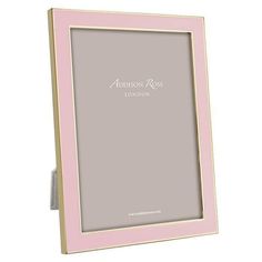 a pink and gold frame with the words london on it's front side, against a white background