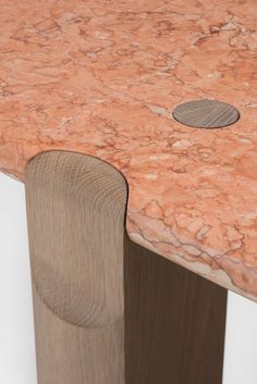 a close up view of a marble top on a wooden table with a hole in the middle