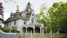 a large white house sitting on the side of a road