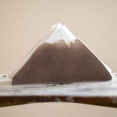 a brown and white mountain sitting on top of a wooden table