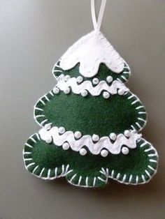 a felt christmas tree ornament hanging on a wall