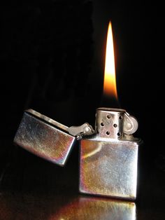 a lighter is sitting on a table with the light coming from it's top