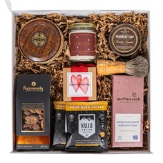 an open gift box filled with chocolates, nuts and other items for valentine's day