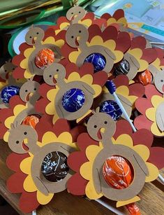 a table topped with lots of candy covered lollipops in turkey shape shapes