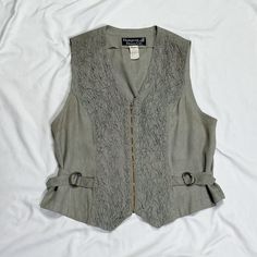 Vintage 1970s/1980s sleeveless vest in grey. In good condition. Note: I try to match colors as much as possible to pictures but there is a possibility it won't be an exact match. Unless the color is completely incorrect I am unable to offer refunds for this reason. Size: 10, fits like a medium Brand is Hampton Dress Co. Measurements (taken on garment laid flat): Armpit to armpit: 19.5" Waist: 37" (can be tightened) Armpit to hem: 9" Length (top of neck to bottom hem): 22.5" Fabric: unable to rea Fitted Gray Sweater Vest For Spring, Vintage Sleeveless Tank Top For Fall, Gray Cotton Vest For Spring, Vintage Sleeveless Sweater Vest For Spring, Hamptons Dress, Match Colors, Grey Vest, Vest Outfits, Casual Tank Tops