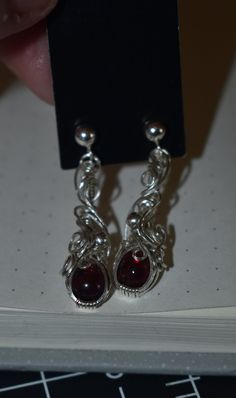 These stunning dangle earrings are so absolutely beautiful!! kind of have a vampire vibe to them lol. These are made with garnet and sterling silver wire/beads. I think these are so cool and they will look absolutely stunning on you!  if interested in making these matching pendants dm me on instagram and id love to arrange that <3 Matching Pendants, Vampire Earrings, Black Vampire, Wire Beads, Blood Drop, Sterling Silver Wire Wrap, Etsy Earrings Dangle, Wire Wrap, Silver Wire