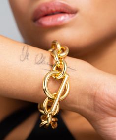 One for the maximalists, the Viveca is an eye-catching cable chain that speaks for itself. Vibrant and feminine, the name Viveca means 'alive' and this iconic piece echoes that feeling, the pièce de résistance on any wrist and a perfect day-to-night design. As bold as it is simple and finished with an oversized toggle clasp. Material: 18ct Gold Plated Brass. Dimensions: Chain Length 22.5cm Formal Gold Bracelet With Cable Chain, Gold Cable Chain Bracelet For Formal Occasions, Modern Chunky Chain Bracelet, Luxury Gold-plated Cable Chain Bracelet, Luxury Gold Plated Cable Chain Bracelet, Bold Jewelry With Adjustable Chain Link, Modern Gold-plated Cable Chain Jewelry, Modern Formal Bracelet With Adjustable Chain, Modern Chain Link Gold Bracelet