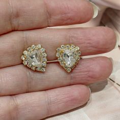 Clip-on earrings Material: gold metal Crystal: white Width: 1.30 cm (0.51") Height: 1.30 cm (0.51") All our objects are vintage and are made by Sphinx, a renowned English company which closed its doors at the beginning of the 2000s and if they seem new to you it is because they come from unsold stock and therefore never worn but nevertheless vintage. Founded in 1948, the Sphinx company was a British manufacturer, famous for its excellent quality costume jewelry. In addition to their own collecti Gold Heart Shaped Clip-on Earrings For Wedding, Metal Crystal Earrings For Anniversary, Metal Heart Earrings With Matching Pair For Wedding, Wedding Metal Heart Earrings, Heart-shaped Clip-on Jewelry For Formal Occasions, Formal Heart-shaped Clip-on Jewelry, Formal Heart Shaped Clip-on Jewelry, Heart-shaped Clip-on Wedding Earrings, Elegant Gold Clip-on Heart Earrings