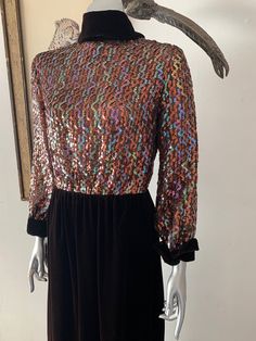 "Amazing 1970s red carpet gown! The sparkly, sequined bodice in the centerpiece to a classic brown velvet rolled high collar, long cuffed sleeve, and straight maxi skirt. Iridescent sequins sewn in vertical wavy design on bodice. High rolled collar with points down the back. Cuffs mirror the collar design. Velvet spine detail with back zip. Hook/eye closures at back neck. Snap closures on cuffs. Bodice is lined with netting. Skirt is lined with with satin. Labelled vintage size 8, but please com Glamorous Fall Sequined Maxi Dress, Glamorous Sequin Maxi Dress For Fall, Formal Sequined Maxi Dress For Fall, Fall Sequin Long Sleeve Maxi Dress, Brown Maxi Dress For Evening In Fall, Brown Maxi Dress For Fall Evening, Brown Fall Evening Maxi Dress, 1970s Style Evening Dresses For Fall, Vintage Formal Maxi Dress For Fall