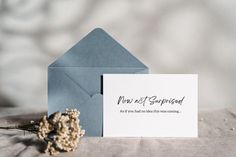 a blue envelope with a note and dried flower on it next to an envelope that says, you not supposed