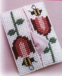 a cross stitch book with two apples on it