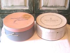 two round tins sitting next to each other on a table