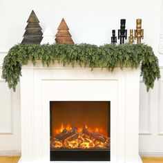 a white fireplace with christmas decorations on top