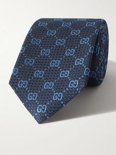 Gucci's tie is jacquard-woven with a textured geometric pattern and the house's iconic 'GG' motif, you'll also find the signature bee emblem embroidered on the label. It's been made in Italy from silk with a classic 7cm profile. Luxury Blue Ties For Business, Luxury Ties For Office Suit Accessories, Luxury Blue Suit And Tie Accessories For Semi-formal Occasions, Luxury Business Suit And Tie Accessories, Luxury Ties For Workwear, Luxury Standard Tie For Work, Luxury Blue Suit And Tie Accessories For Office, Luxury Silk Mark Certified Ties For Business, Luxury Silk Mark Certified Business Ties