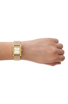 A mix of Roman numeral and stick indices mark the rectangular dial of this elegant watch housed on a tri-tone bracelet. 25mm x 34mm case; 16mm band width Deployant clasp closure Quartz movement Mineral crystal face Stainless steel/goldtone plate Imported Classic Watch With Jubilee Bracelet And Rectangular Dial, Gold Analog Watch With Rectangular Face, Gold Watches With Jubilee Bracelet And Rectangular Dial, Gold Rectangular Analog Watch, Gold Rectangular Analog Jewelry And Watches, Rectangular Gold Analog Watch, Gold Rectangular Watch With Jubilee Bracelet, Tory Burch Watch, Elegant Watch