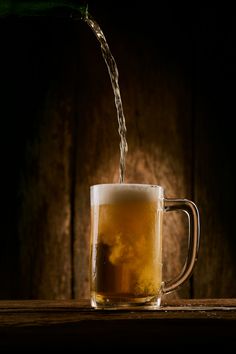 a beer being poured into a mug