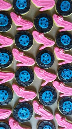 pink and blue decorated cupcakes with black buttons