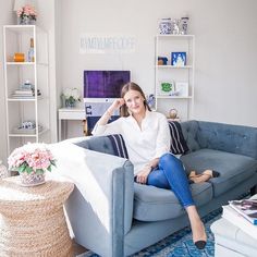 a woman sitting on top of a blue couch