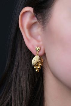 These 22k solid gold grape earrings are unique design. They will make a nice oscillation in your ear with their dangle earrings feature. With their distinctive style, these fruit earrings can be a thoughtful mother in law gift. * Earrings weight: Approx. 3,45 grams * There may be 10% -) deviation margin in the weight of the products. * Temiroglu Gold products are real solid gold. It is definitely not gold plated, not gold filled. * All products are presented to you in high quality jewelry boxes. * Depending on your request, we can provide delivery in the form of a gift package. Express Shipping Process    * United States: 4-6 business days    * Canada: 4-6 business days    * Australia: 4-6 business days    * UK: 4-6 business days    * Worldwide: 2-7 business days Please contact us if you h Real Gold Earrings Designs, 22k Yellow Gold Chandelier Earrings As Gift, Daily Wear Earing Design Gold, Gold Earrings Designs 4 Grams, 22k Gold Dangle Jewelry For Anniversary, 22k Gold Drop Chandelier Earrings As Gift, 22k Gold Dangle Earrings, 22k Gold Drop Chandelier Earrings For Gift, Gift 22k Gold Drop Chandelier Earrings