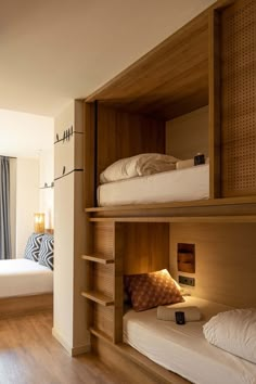 a room with bunk beds and wooden shelves