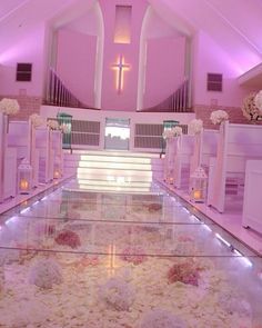 the aisle is decorated with flowers and candles