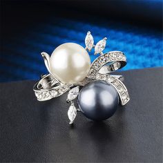 Elevate every outfit when you decorate your digits with this dazzling silvertone ring embellished with sparkling cubic zirconia. 0.91'' W Silvertone copper / cubic zirconia / imitation pearl Birthday Proposal, Measure Ring Size, Pearl And Diamond Ring, Birthday Ring, Jewelry Rings Diamond, Finger Rings, Chic Jewelry, Black Pearl, White Ring