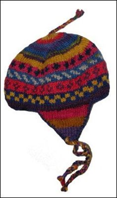 a multicolored knitted hat with a knot at the end and a tassel