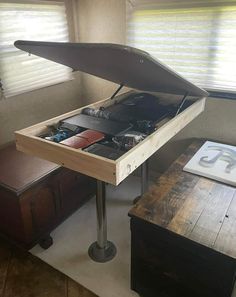 an open suitcase sitting on top of a wooden table