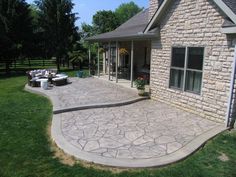 an outdoor patio with concrete pavers and seating area