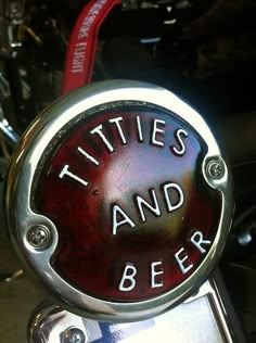 a close up of a red and black sign on a motorcycle