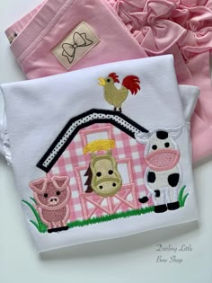 two pink and white shirts with farm animals on them, one in front of the other