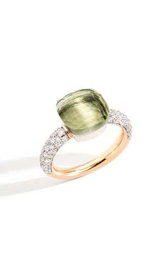 a green and white diamond ring on a white background with the shadow of it's face