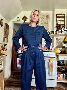 Pretty rad vintage barely worn jumpsuit  Navy blue with a light sheen to the material  Polyester cotton material  Buttons down front one button near the bottom needs a stitch  Elastic back waist  Chest pockets  Side pockets  Pleated pant line at the front hip  Amazing vintage condition  I don't think this was really worn  Tag reads size medium  Fits like a medium/small large  Measurements are approximate and taken flat so please double bust waist and hips for more accurate sizing  Bust: 18.5 in Retro Long Sleeve Jumpsuit For Fall, Vintage Long Sleeve Jumpsuit For Work, Retro Long Sleeve Jumpsuits And Rompers For Fall, Vintage Long Sleeve Jumpsuits And Rompers For Work, Vintage Long Sleeve Jumpsuits And Rompers For Fall, Vintage Long Sleeve Overalls For Spring, Vintage Jumpsuits And Rompers For Fall, Fitted Vintage Denim Jumpsuit With Long Sleeves, Vintage Fitted Long Sleeve Denim Jumpsuit