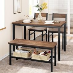 a dining room table and chairs with baskets under the table next to it on carpeted flooring