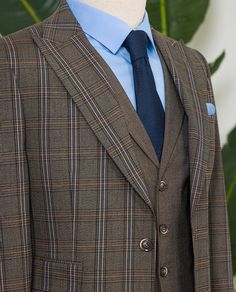 Color: brown plaid Material: 63% polyester, 34% viscose, 3% elastane Suit includes: blazer, vest, and pants Single-breasted suit (2-button blazer) Lapel type: peak lapels Jacket interior lining option: fully-lined Jacket vent: single vent Fitting: slim-fit Care instructions: dry clean only Machine washable: no Brown Single Breasted Business Sets, Brown Single Breasted Set With Notch Lapel, Brown Single Breasted Sets With Notch Lapel, Brown Single-breasted Notch Lapel Set, Brown Single-breasted Sets With Notch Lapel, Fitted Brown Three-piece Suit For Office, Brown Three-piece Suit With Notch Lapel For Business, Brown Three-piece Notch Lapel Suit For Business, Tailored Brown Three-piece Suit With Notch Lapel