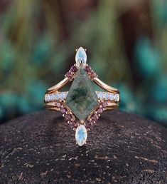 Vintage moss agate engagement ring set kite shaped marquise moonstone ring curved wedding band art deco rose gold anniversary promise ring engagement ring: https://www.etsy.com/listing/932744615/vintage-alexandrite-engagement-ring?ref=listings_manager_grid https://www.etsy.com/shop/BrilliantRing?ref=l2-shopheader-name --------------------Specifications---------------------- Engagement Ring: Center Stone - 9*15mm kite shaped moss agate Side Stones - about 0.35ct Moonstone Wedding Band 1: Stones: Marquise Diamond Multi-stone Jewelry, Art Deco Cabochon Jewelry For Anniversary, Fine Jewelry With Multi-stone Marquise Cut, Unique Moonstone Ring With Rose Cut Diamonds For Wedding, Elegant Moonstone Jewelry With Prong Setting, Art Deco Cabochon Rings For Weddings, Art Deco Cabochon Wedding Rings, Handmade Art Deco Jewelry For Anniversary, Fine Jewelry Marquise Rose Gold