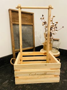 a wooden crate sitting on top of a floor next to a vase with flowers in it