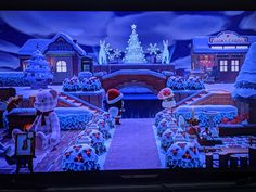 an animated christmas scene is shown on the television