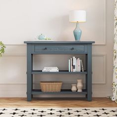 a blue shelf with books on it next to a lamp and curtains in a room