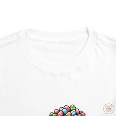 Elevate your child's style game with our Airlume Combed Toddler Short Sleeve Tee in Various Colors! This Bella Canvas tee is crafted from 100% Airlume combed and ring-spun cotton jersey, ensuring a soft and comfortable fit for your little one. Whether your toddler prefers bold hues or classic neutrals, our tee comes in a wide array of colors to suit every taste.Featuring an extra light fabric weight of 3.9 oz/yd² (132 g/m²) and a tear-away label for added comfort, this tee is perfect for everyda Casual White Top For Birthday, Multicolor Cotton Tops For Birthday, Playful Short Sleeve Tops For Easter, Playful Easter Tops With Graphic Print, Easter Graphic Print Playful Tops, Playful White Long Sleeve T-shirt, White Relaxed Fit Top For Birthday, Fun Cotton Tops For Easter, White Graphic Tee For Birthday