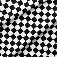 black and white checkerboard fabric with diagonal stripes in the center, as if it were woven into a wallpaper