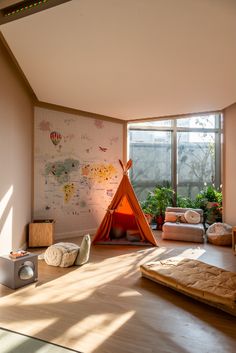 a child's playroom with a teepee tent in the corner