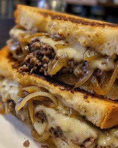 a close up of a sandwich on a plate with meat and onions in it,