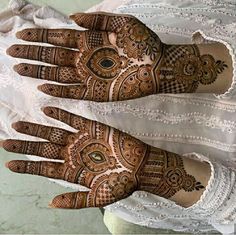 two hands with henna designs on them