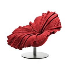 a red chair with pleated fabric sitting on top of a metal stand in front of a white background