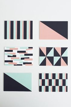 six different geometric designs on a white wall with black, pink and blue stripes in the middle