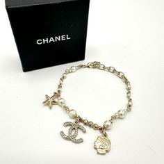 100% Authentic Chanel Champagne Pearl Rhinestone Star Bracelet Condition: 9/10 Dimensions: 6.5-8.5” Wearable Length"W Inclusions: Box Details: Hardware Is Shiny With Minimal Hairline Scratches, Minimal Scuffs On The Back Of The Head Charm And No Tarnish. One Pearl Has One Tiny Scuff. Chanel Champagne, Jewelry Chanel, Back Of The Head, Chanel Jewelry, Star Bracelet, 9 And 10, Champagne, Chanel, Bracelet